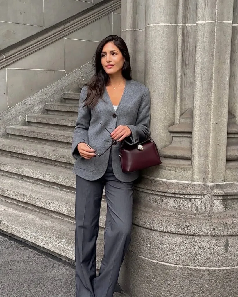 Gray tailored suit with burgundy handbag New York business outfit