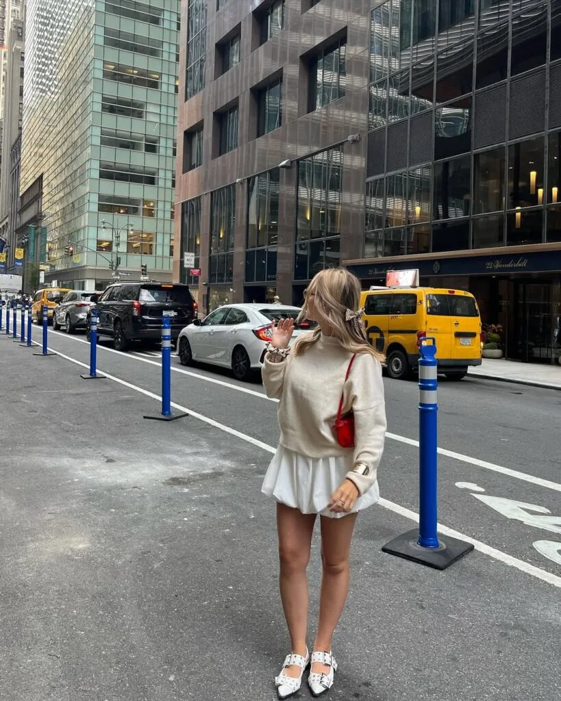Oversized sweater white mini skirt red handbag city outfit