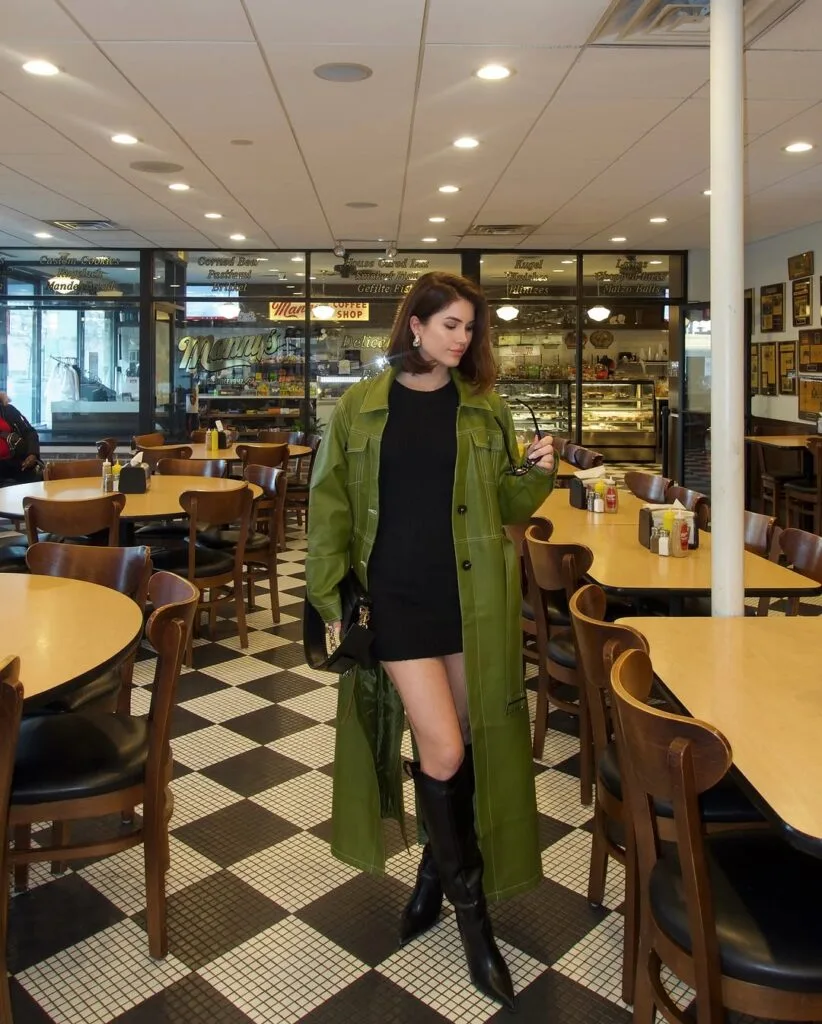 Green leather coat black mini dress and knee high boots