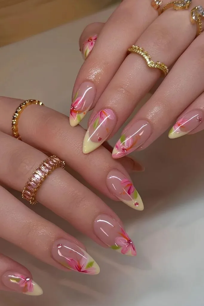 Tropical floral French stiletto August nails with floral French tips on dramatic stiletto nails.