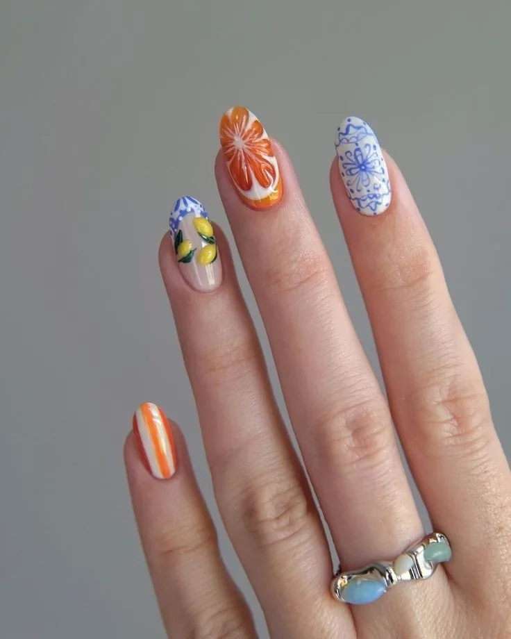 Citrus and tile-inspired August nails featuring Mediterranean patterns and colorful citrus artwork.