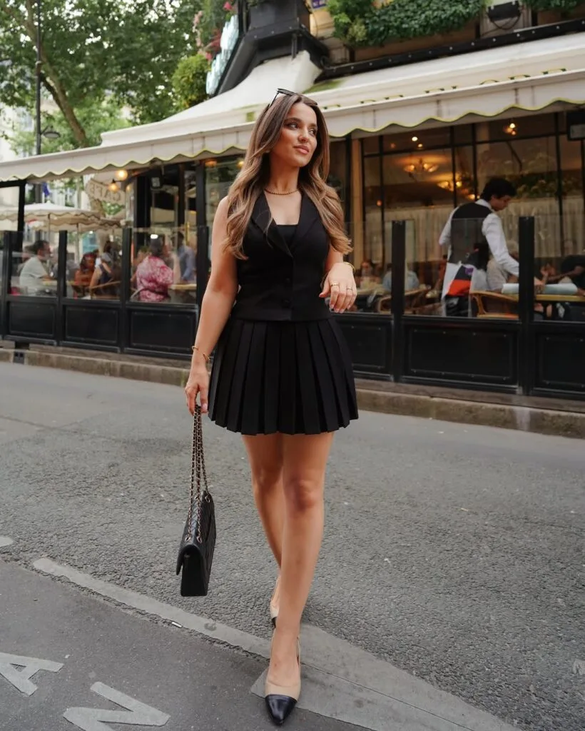 Black tailored vest with pleated mini skirt