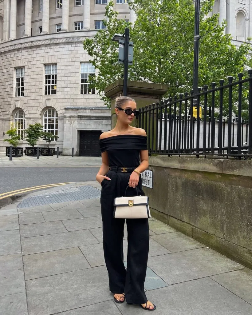Off-shoulder black top with wide-leg trousers