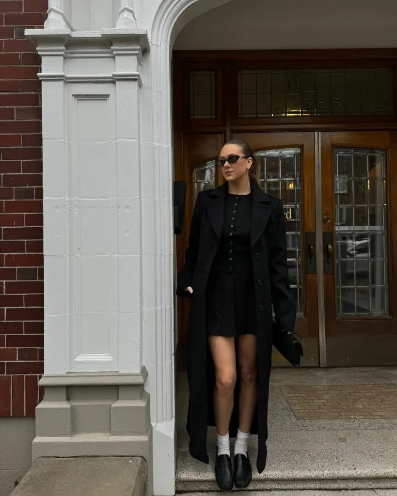 Long black coat with textured mini skirt