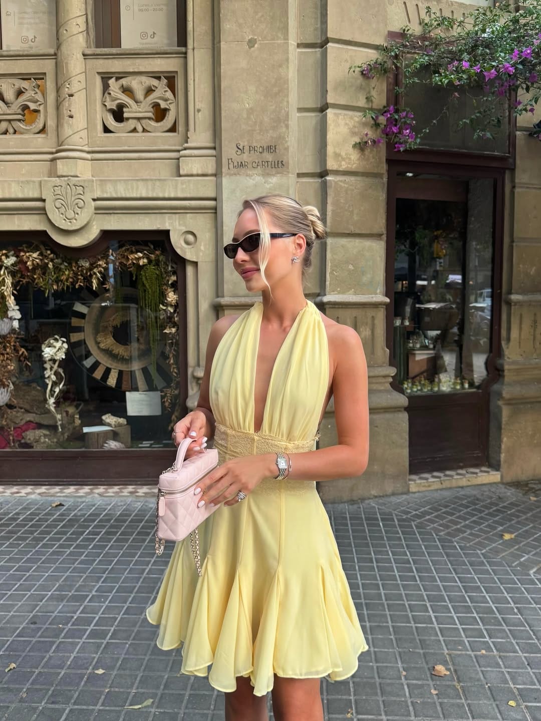 Butter yellow deep-V halter mini dress with pink quilted bag chic outfit