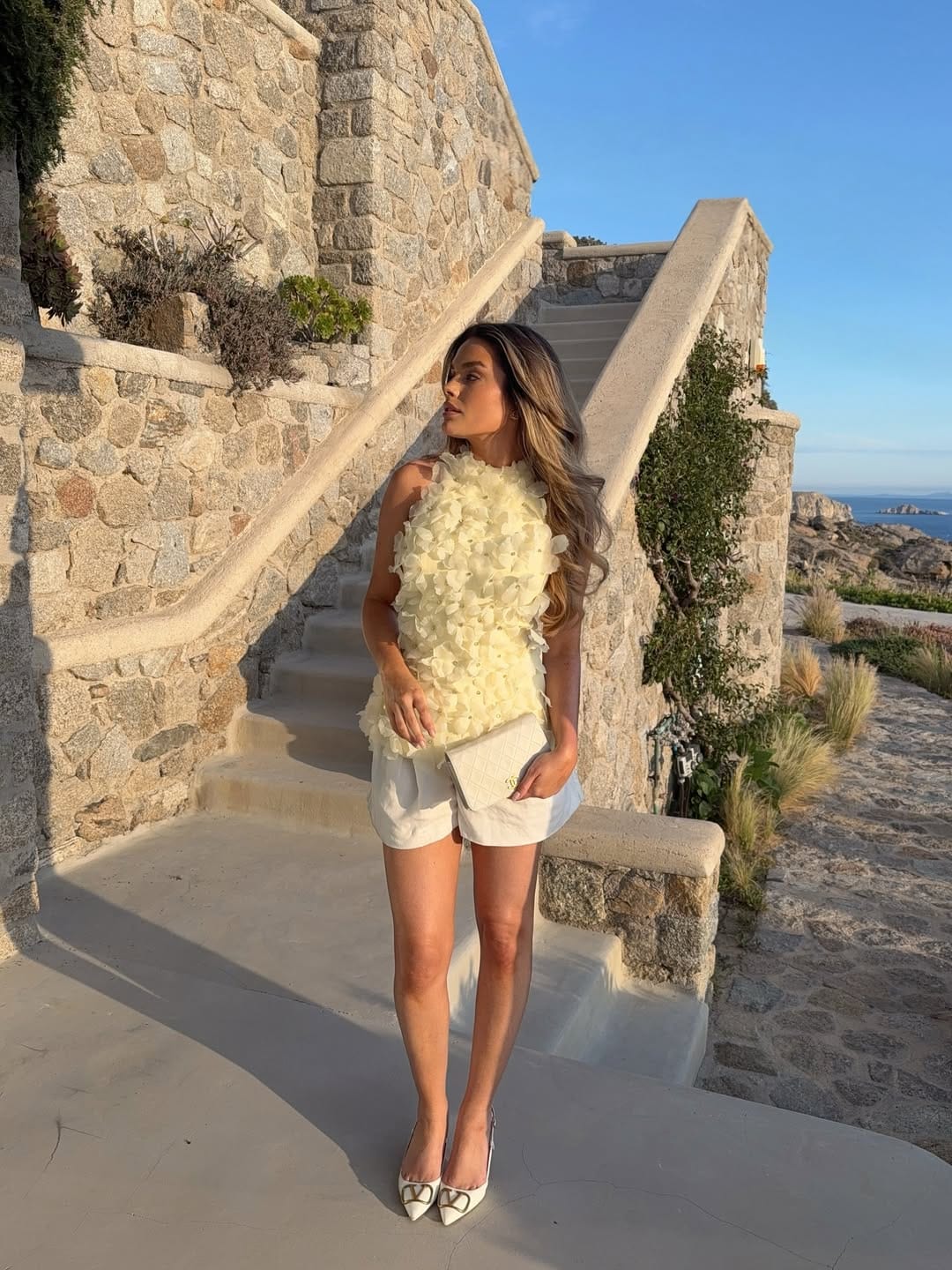 Butter yellow petal appliqué top with white tailored shorts elegant summer outfit