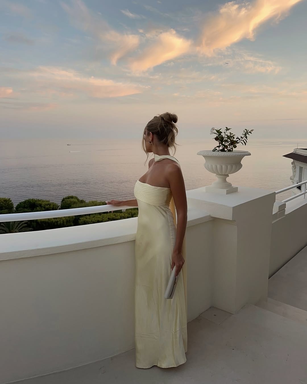 Butter yellow halter neck pleated maxi dress at sunset dreamy summer outfit