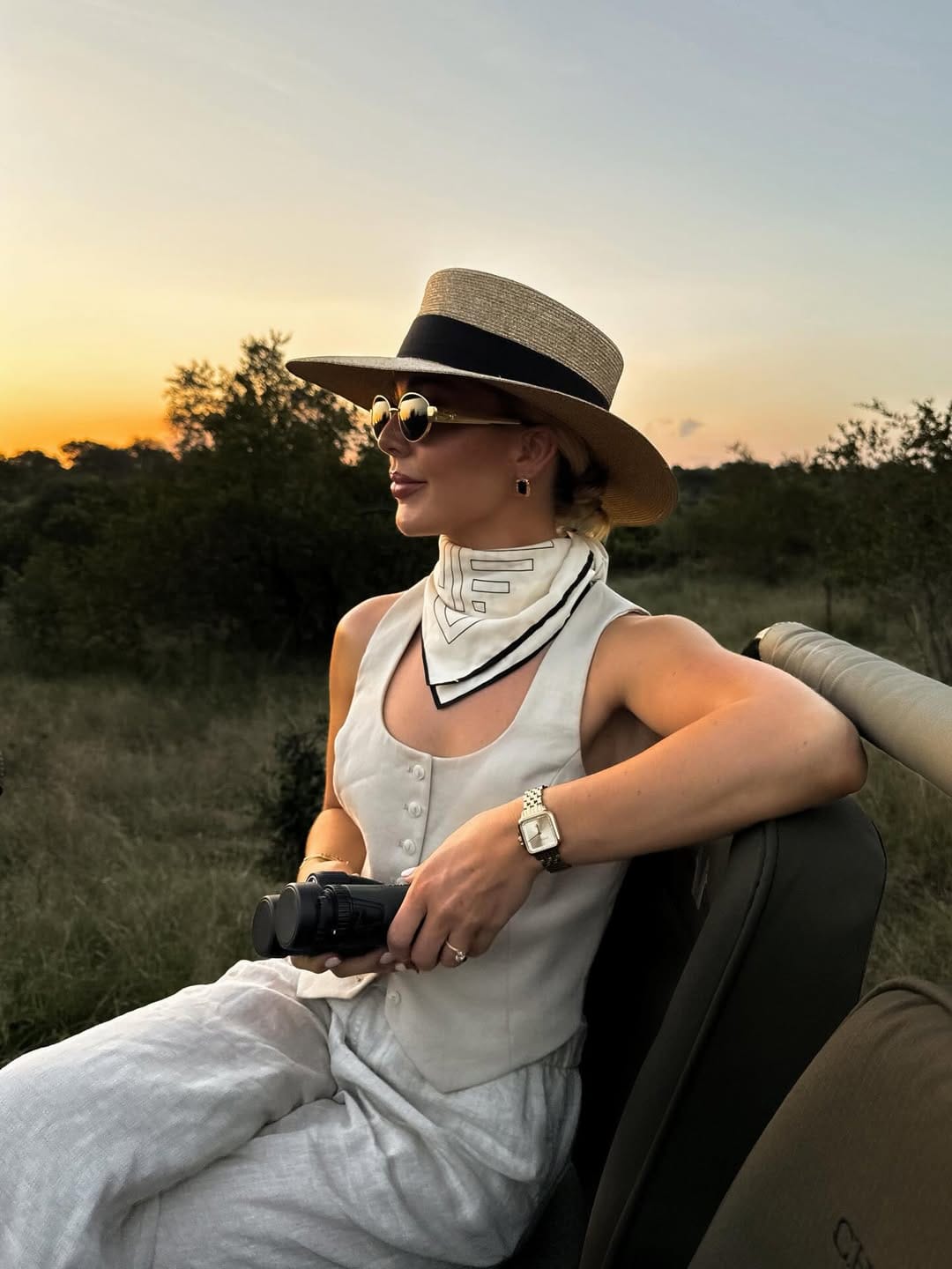 White linen vest top paired with wide-leg trousers and a silk neck scarf