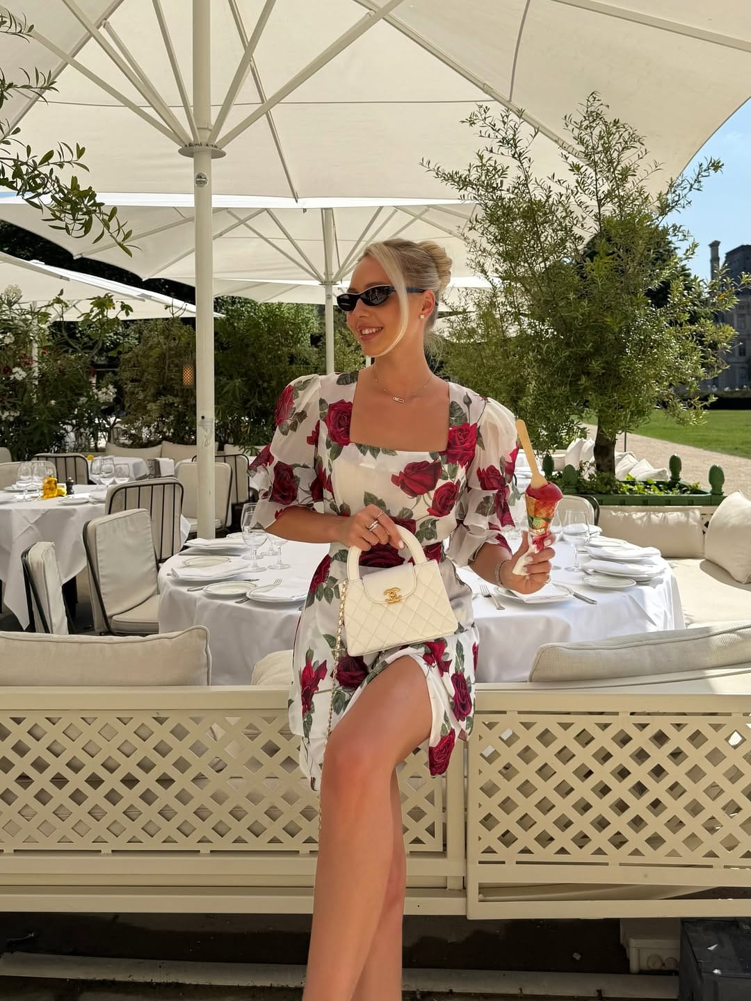 Red rose print square neck dress styled with a Chanel bag