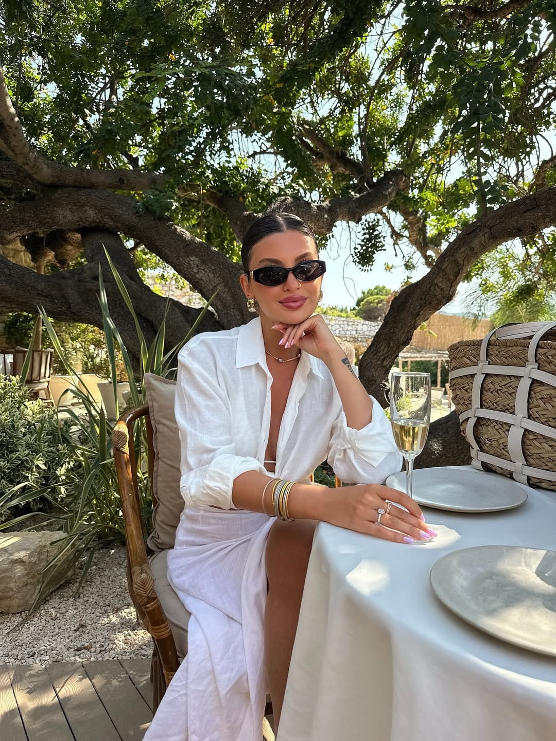 White linen shirt dress styled with gold bangles for an effortless look