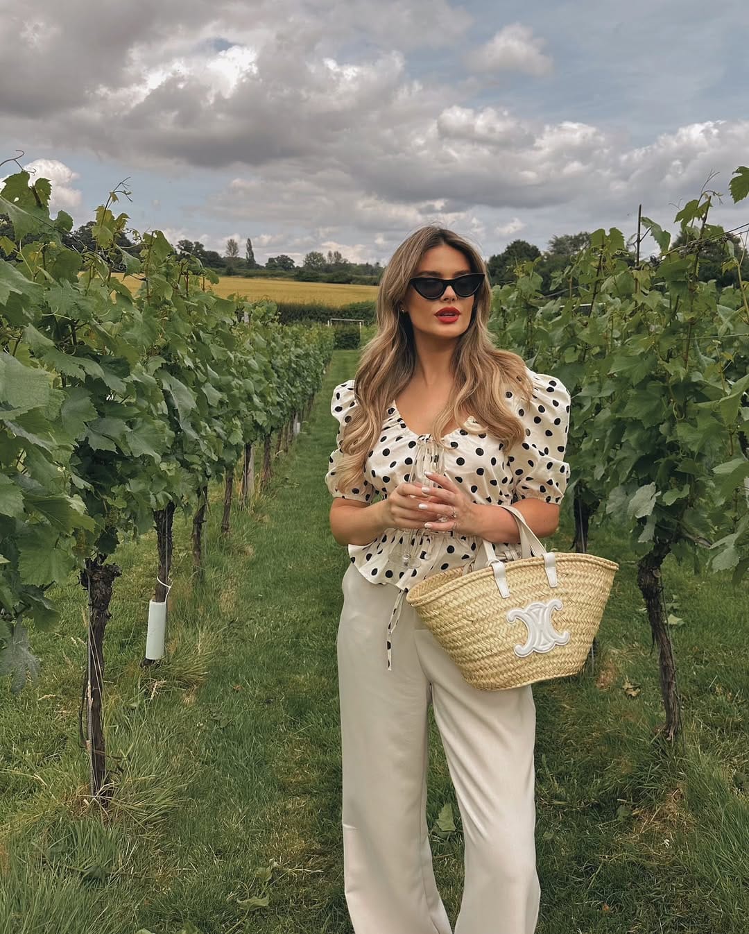 Polka dot puff sleeve blouse paired with cream wide-leg trousers