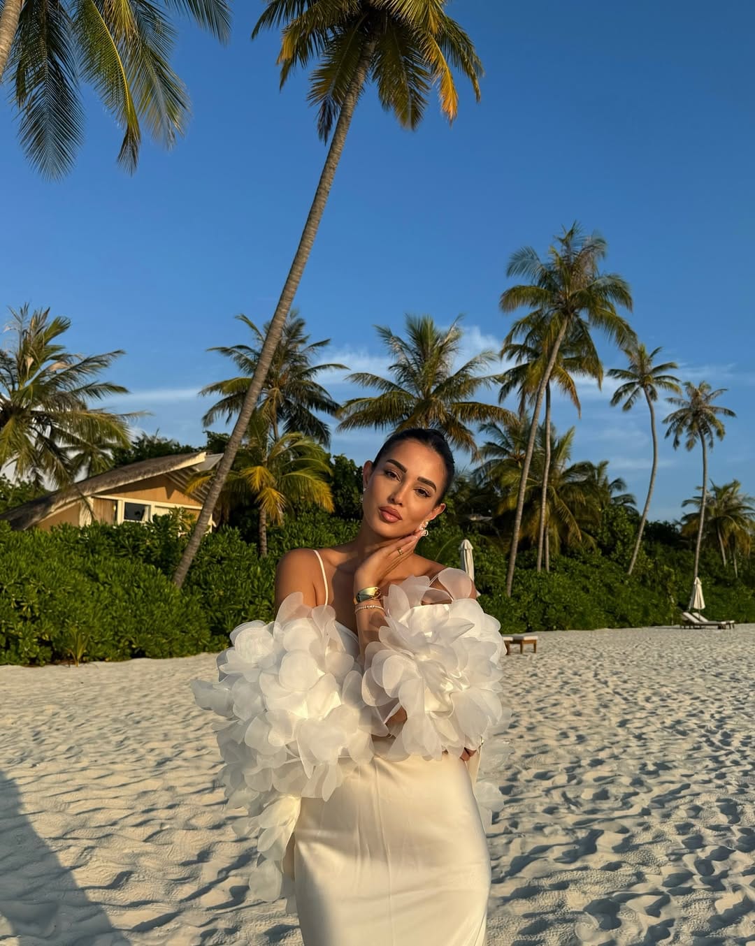 White organza petal sleeve column maxi dress with pearl earrings on Maldives beach outfit idea