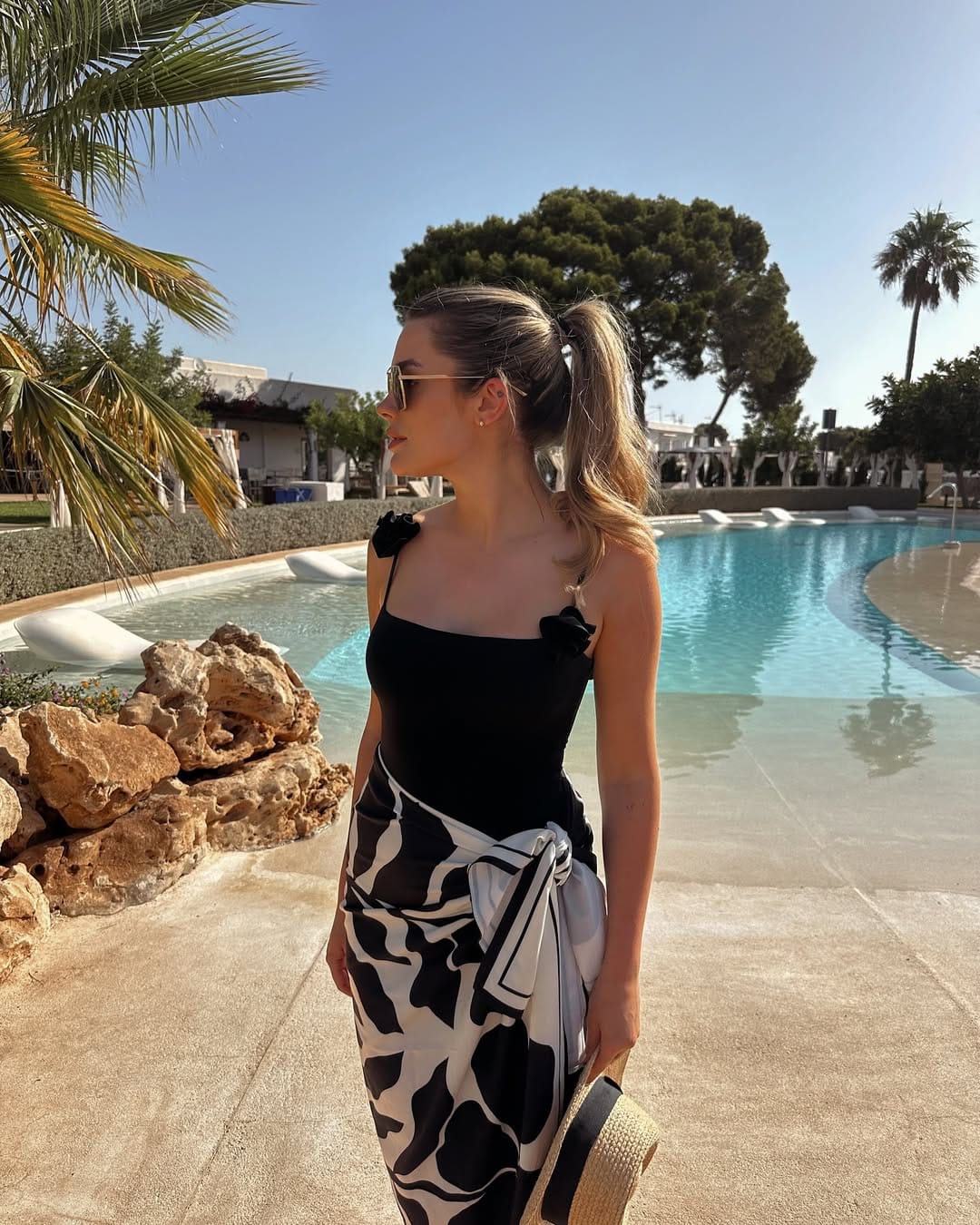 Black bodysuit with black and white abstract print sarong at hotel pool beach outfit idea