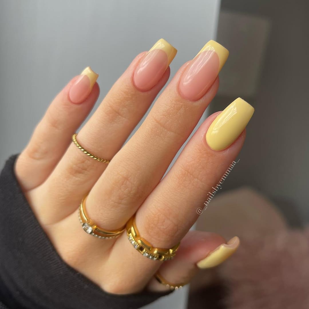 Butter yellow French tip nails with a mix of classic and modern styles