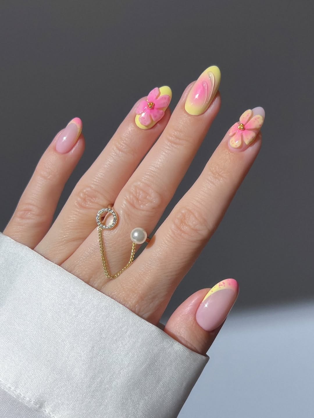 Butter yellow and hot pink almond nails with 3D floral details