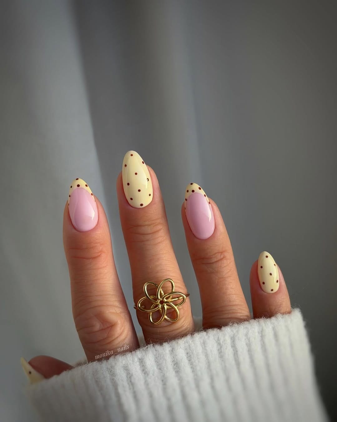 Butter yellow and soft pink almond nails with polka dot accents