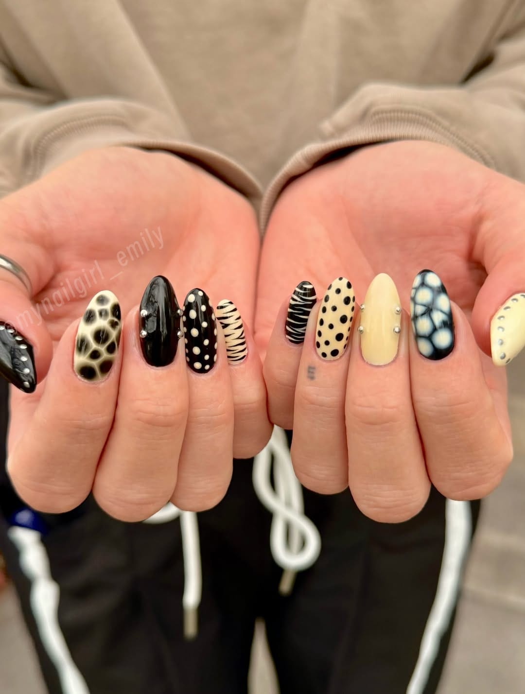 Butter yellow accent nails combined with bold black and white animal print