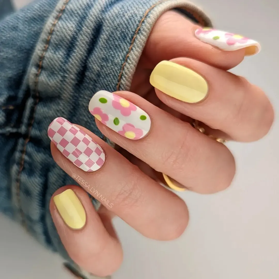 Butter yellow nails with pink checker pattern and retro flower design