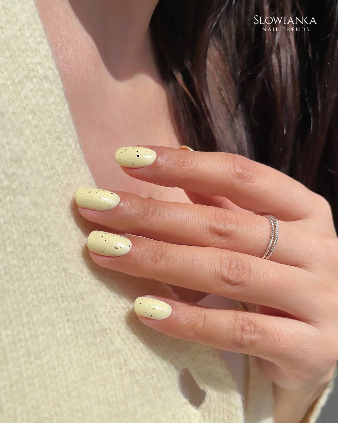 Butter yellow speckled oval nails with a minimal textured look