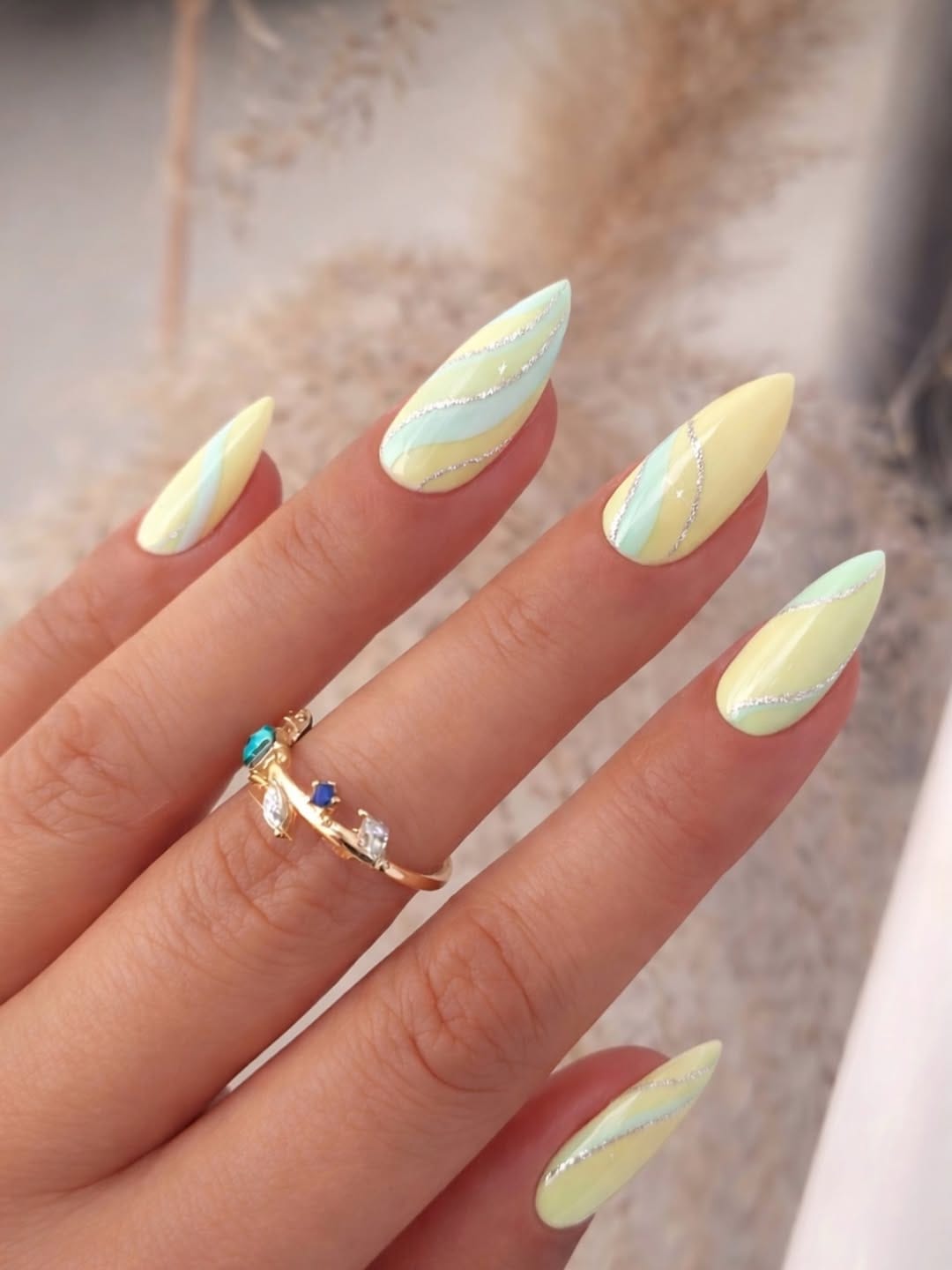 Butter yellow and mint swirl almond nails with a soft pastel vibe
