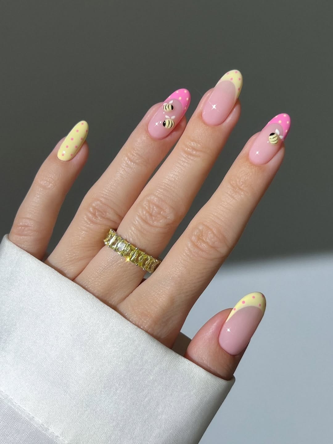 Butter yellow French tip nails with hot pink bee details