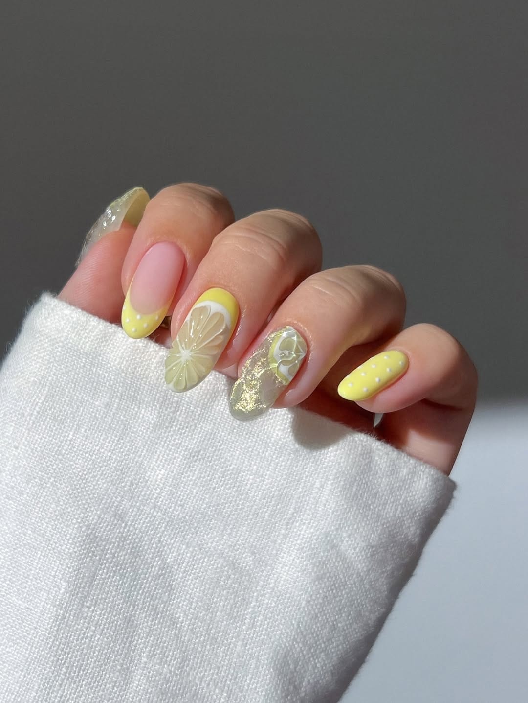 Lemon slice nail art paired with butter yellow French tips