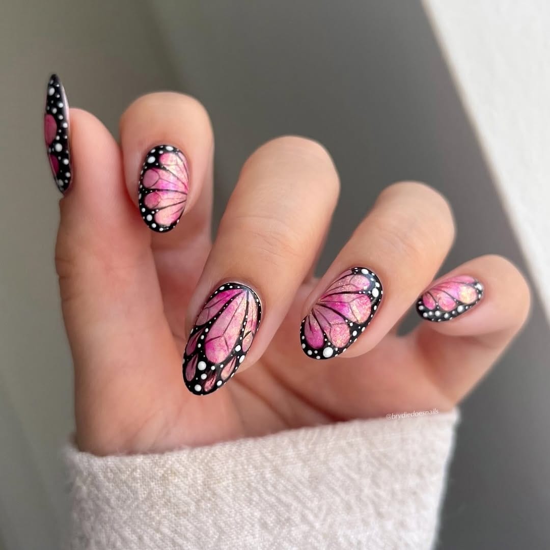 Pink almond nails with full-coverage monarch butterfly wing design