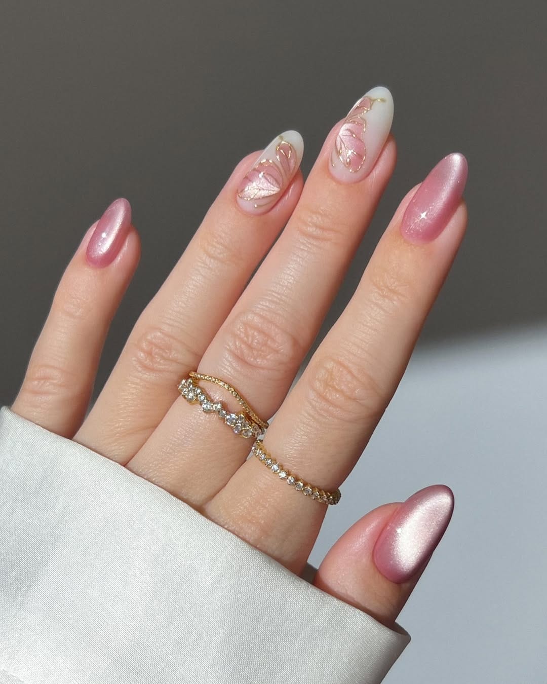 Rose pearl chrome almond nails with gold outline butterfly detail