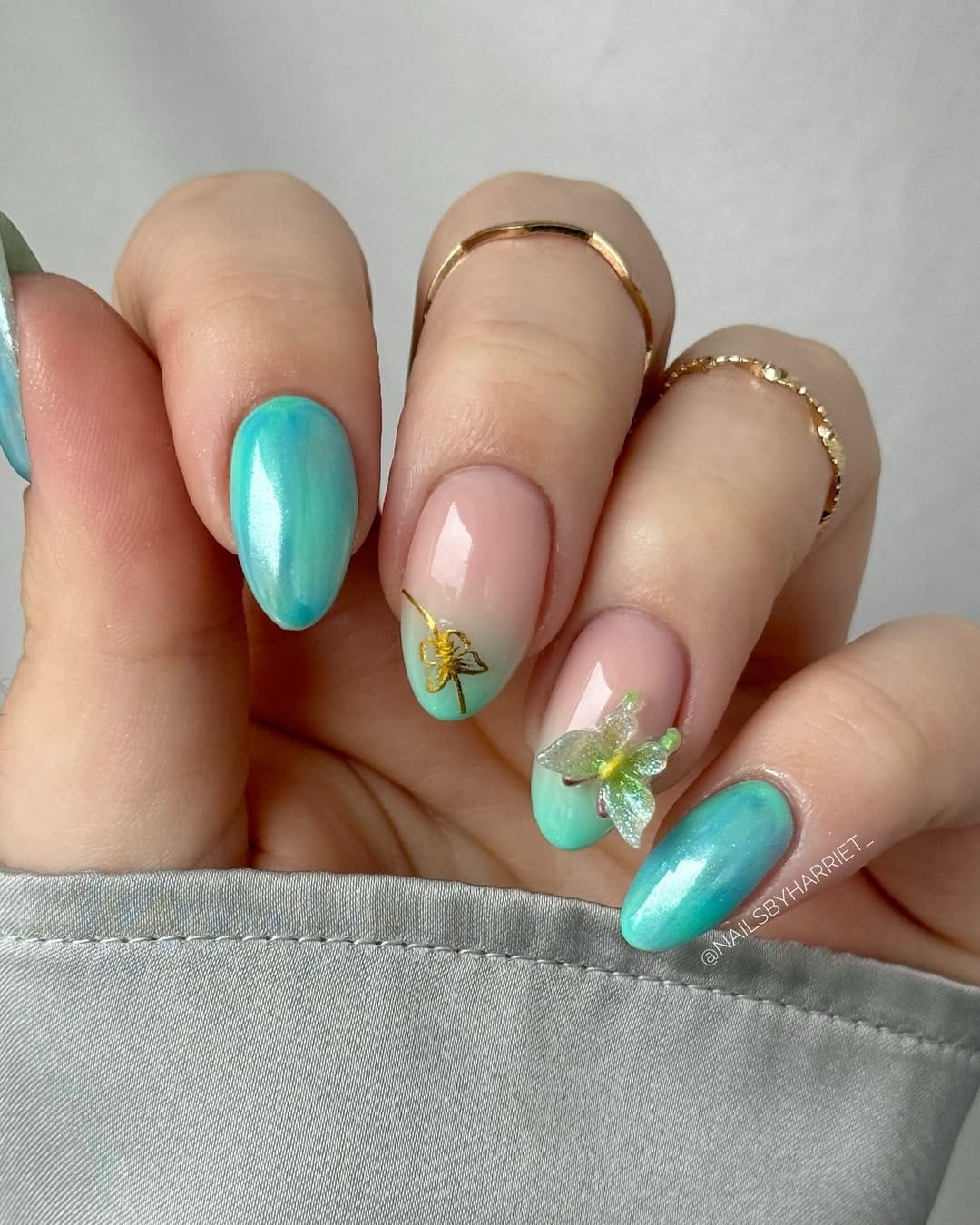 Aqua chrome almond nails with 3D butterfly and dragonfly accents