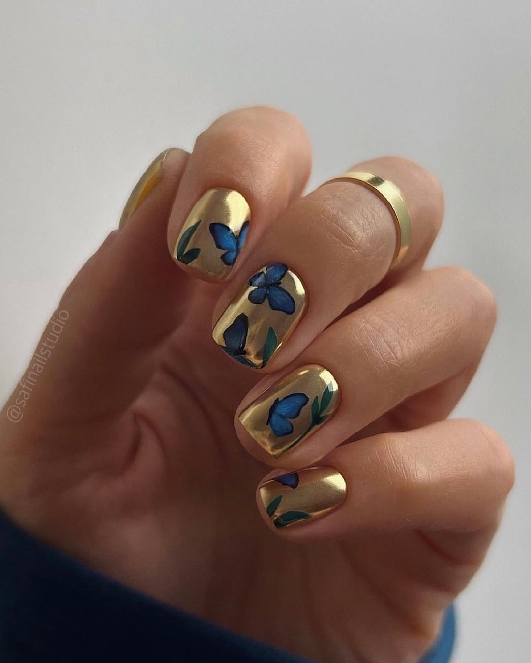Gold chrome square nails with blue morpho butterfly and botanical details