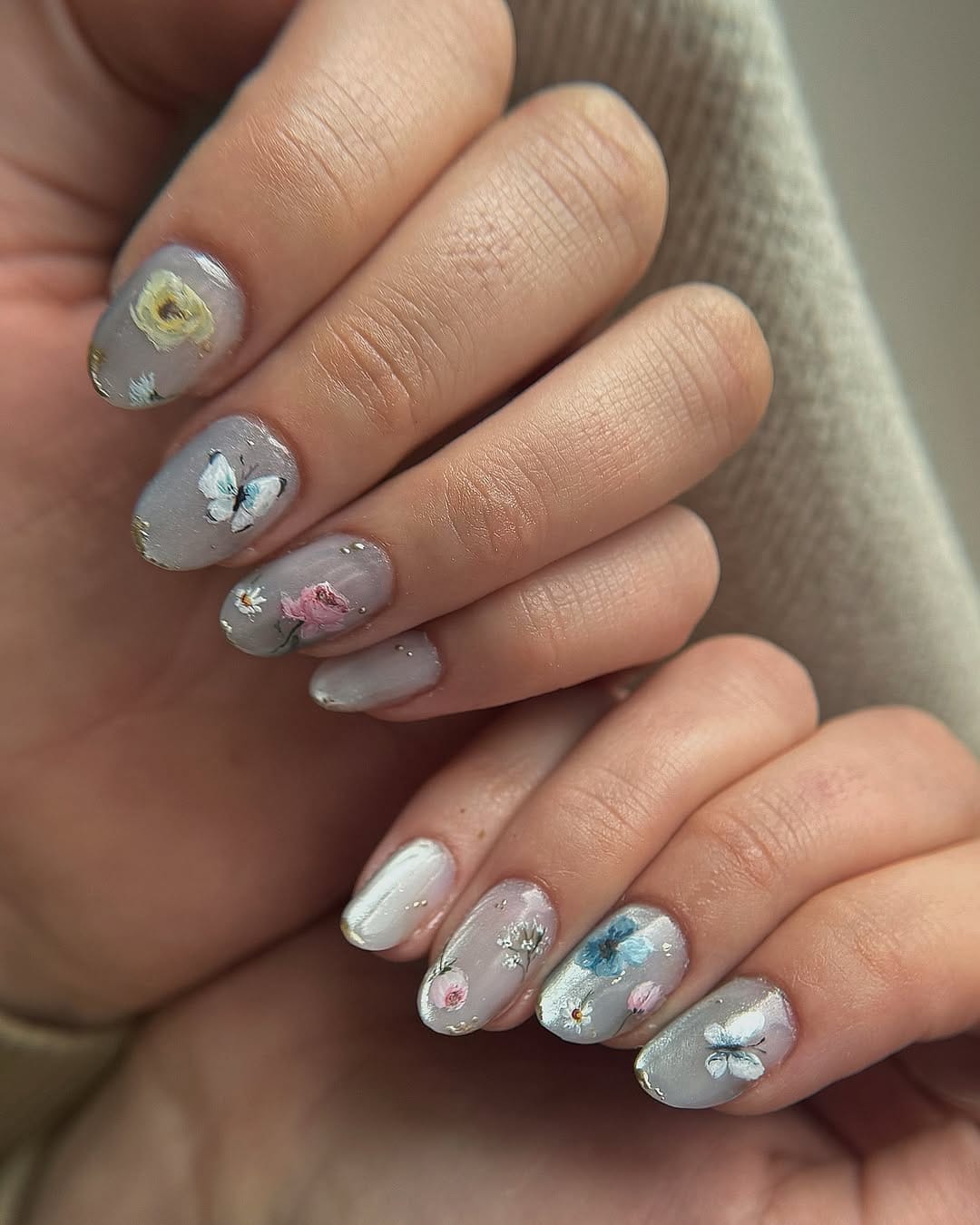 Smoky grey lavender oval nails with blue butterfly and painted rose details