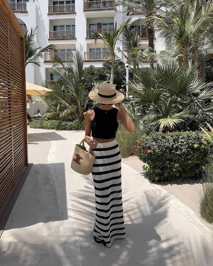 Black and white striped crochet maxi skirt paired with a minimal top for a chic look