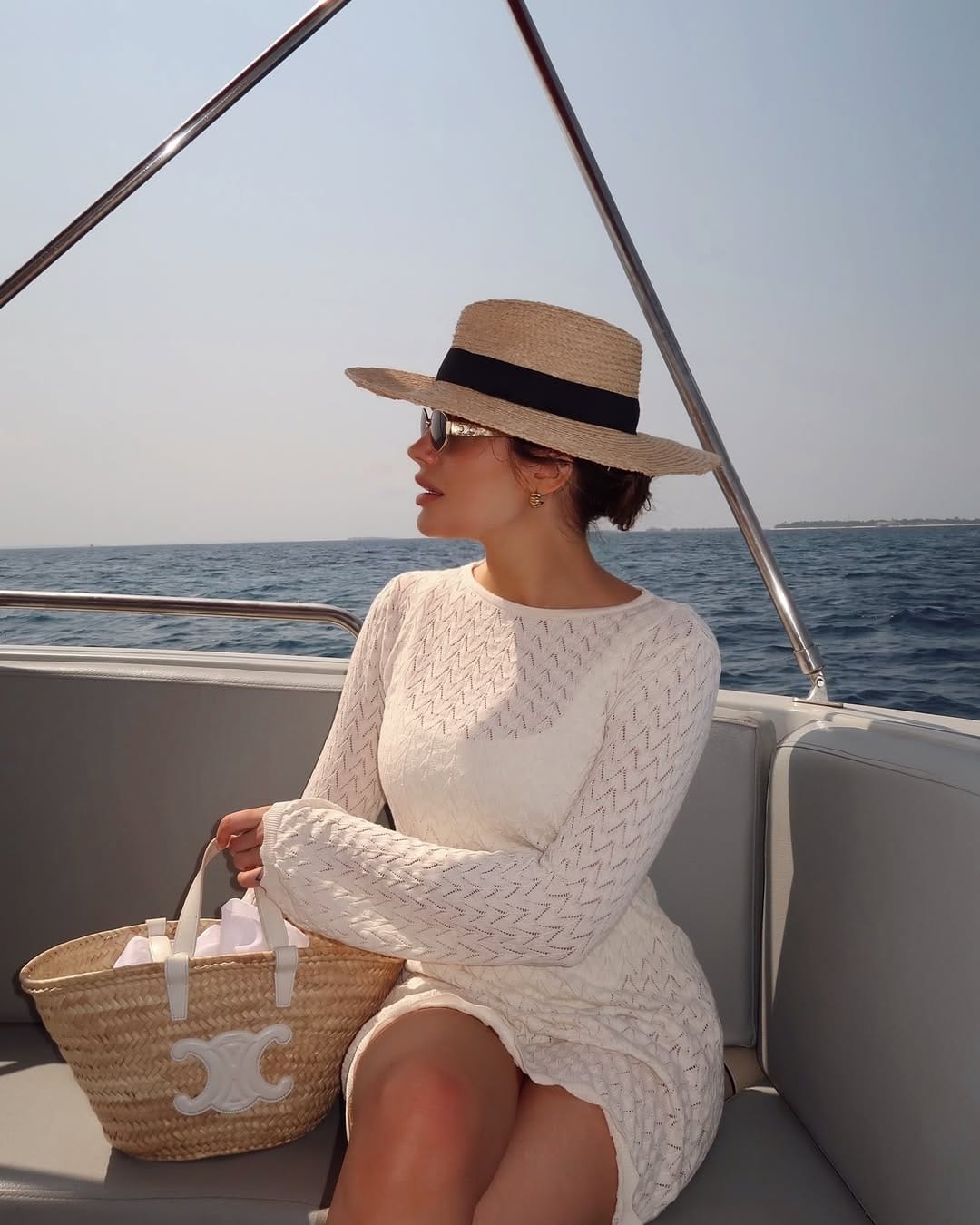 White pointelle knit mini dress styled on a boat for a breezy coastal look