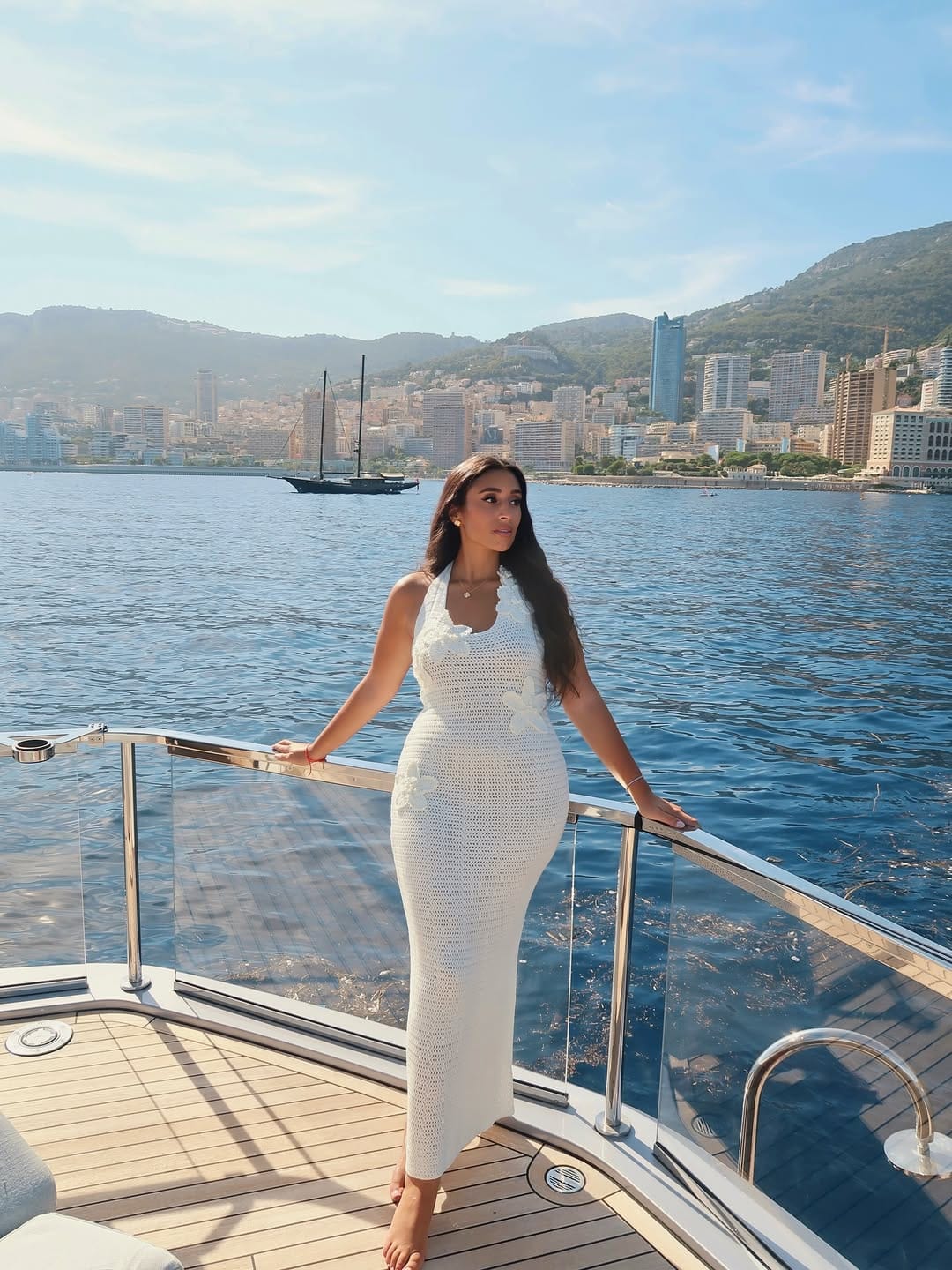 White crochet body-con halter midi dress with floral appliqué on a yacht deck in Monaco