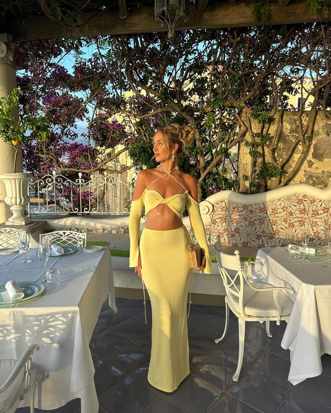 Butter yellow knit halter cut-out co-ord at a Positano restaurant terrace, Italian summer evening outfit