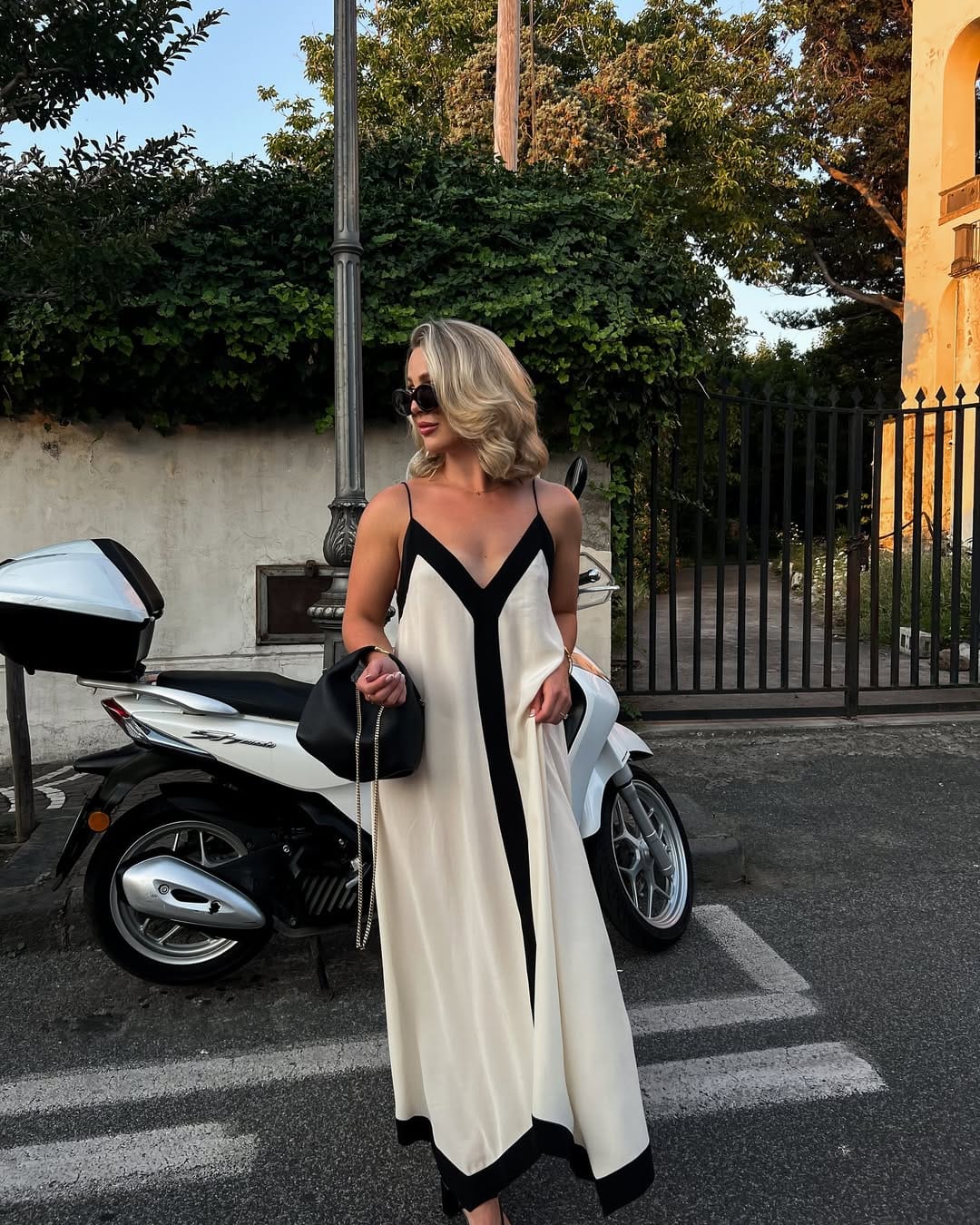 Cream and black colourblock satin slip maxi dress at Taormina golden hour, Italian summer evening outfit