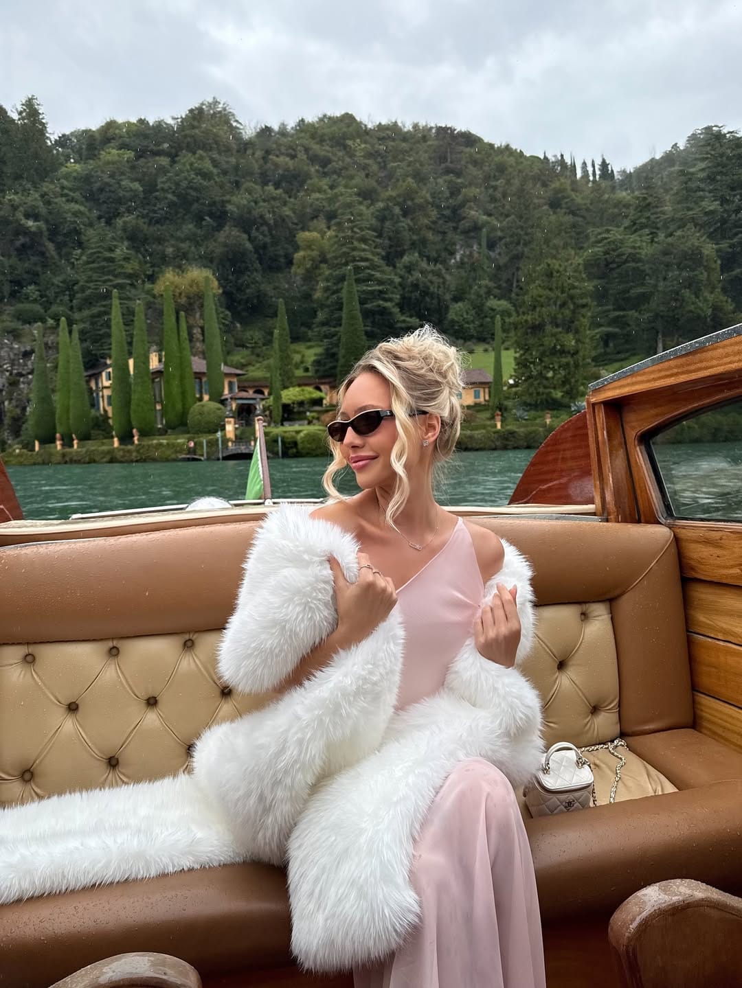 Blush satin asymmetric slip dress under white faux fur coat with Chanel vanity bag, Lake Como outfit idea