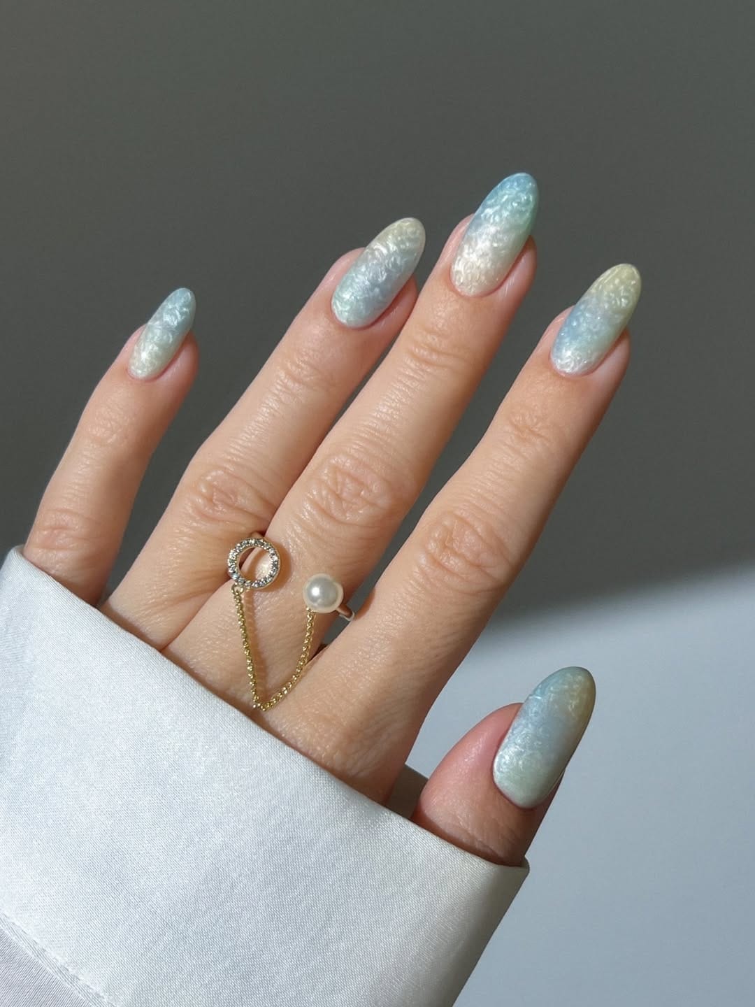Iridescent crushed shell texture almond nails with a glossy finish