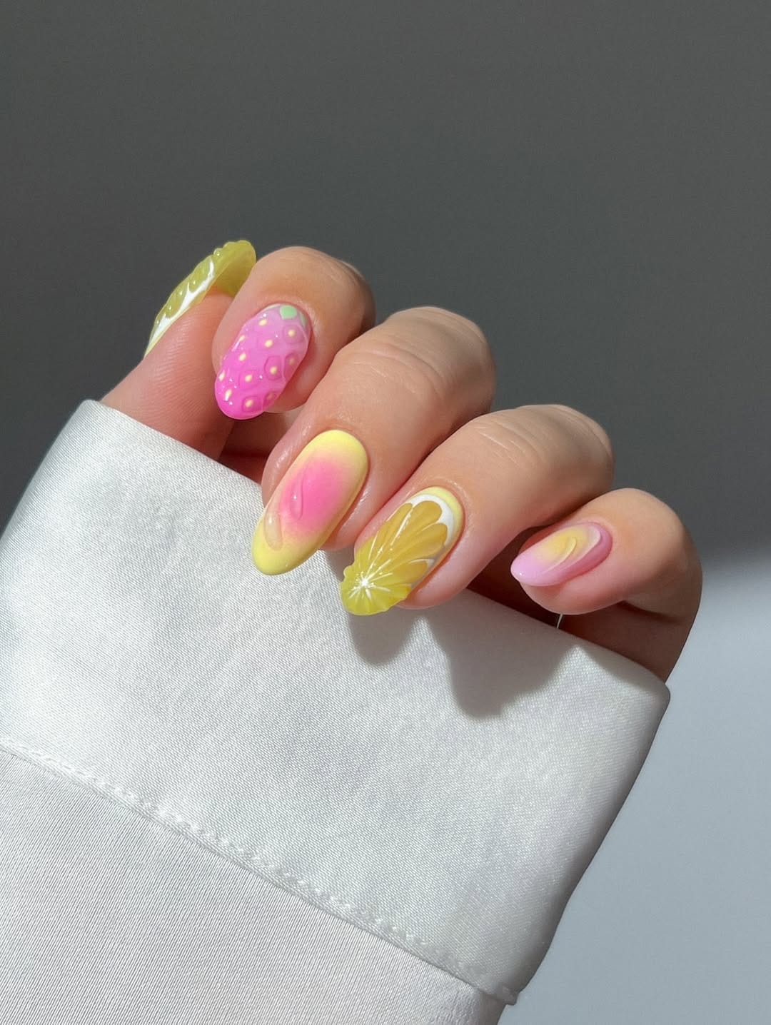 Pink and yellow sorbet ombré almond nails with 3D strawberry and lemon art