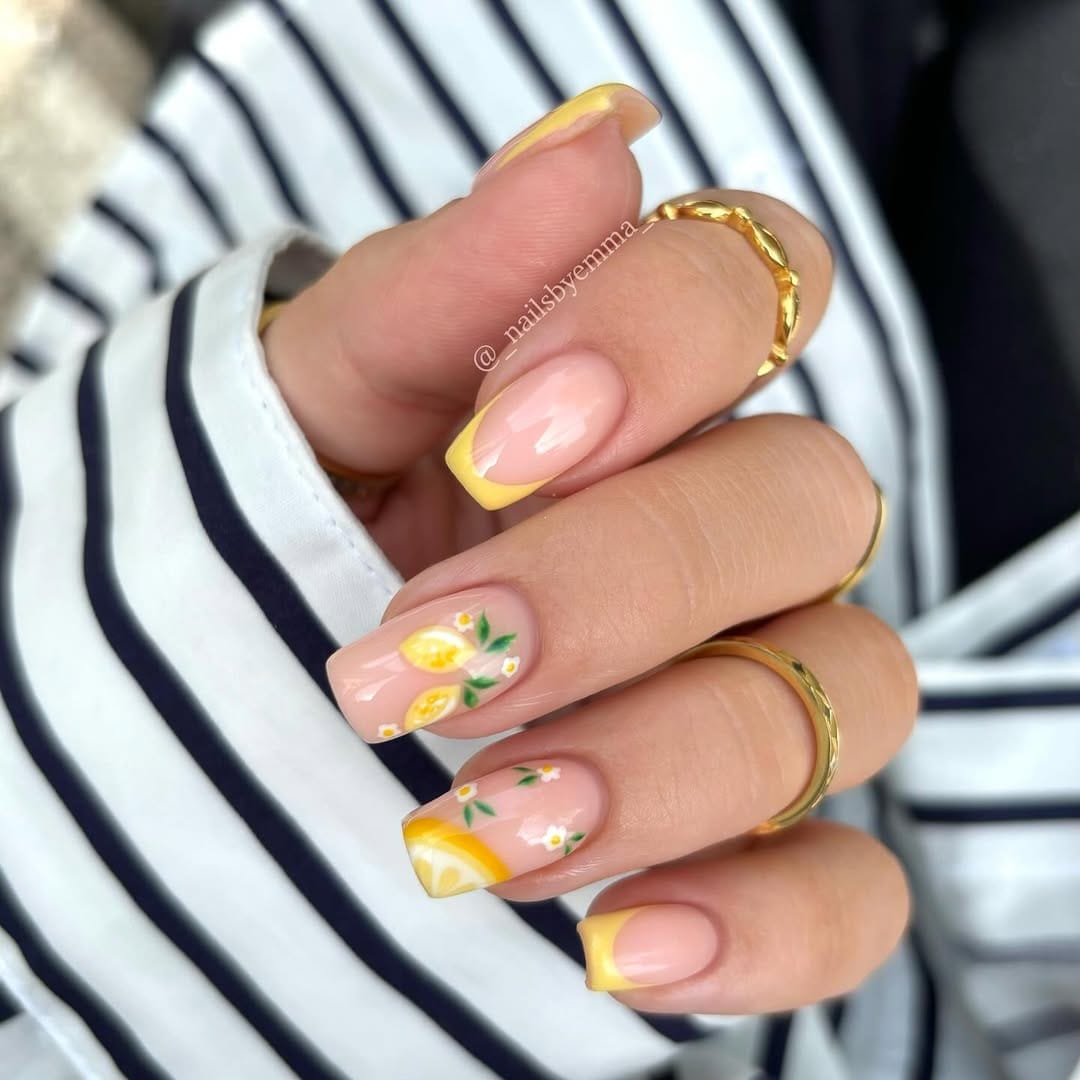 Yellow French tip square nails with lemon slice and daisy accents