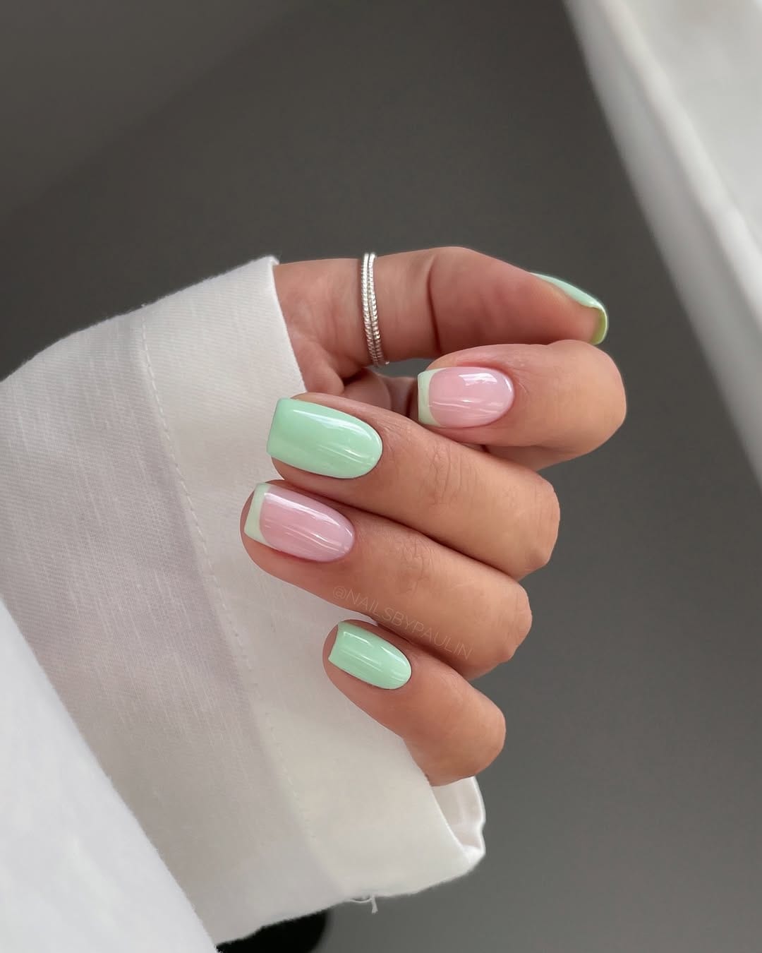 Mint green and soft pink square nails with tonal French tip design