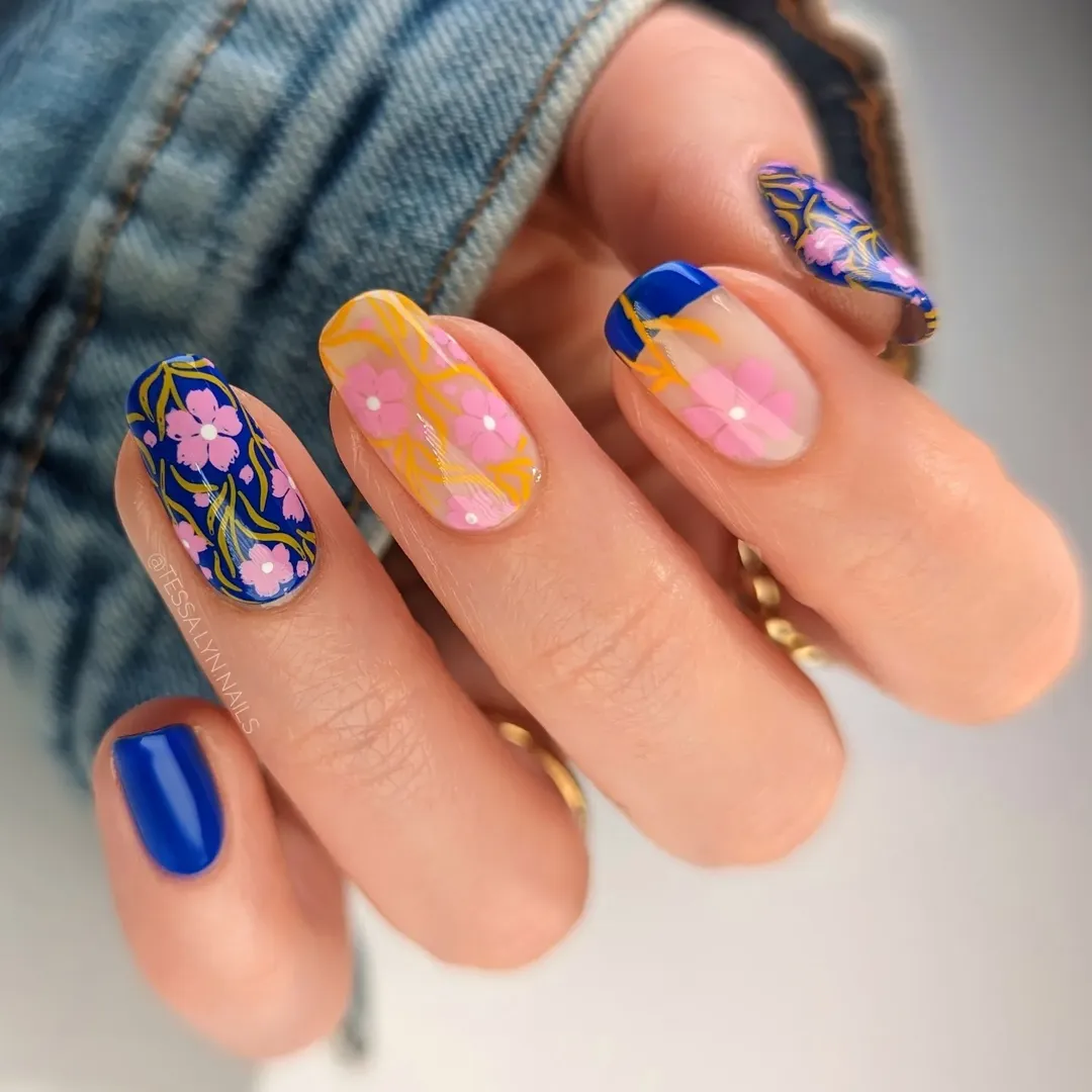 Cobalt blue short round nails with bold pink floral botanical art