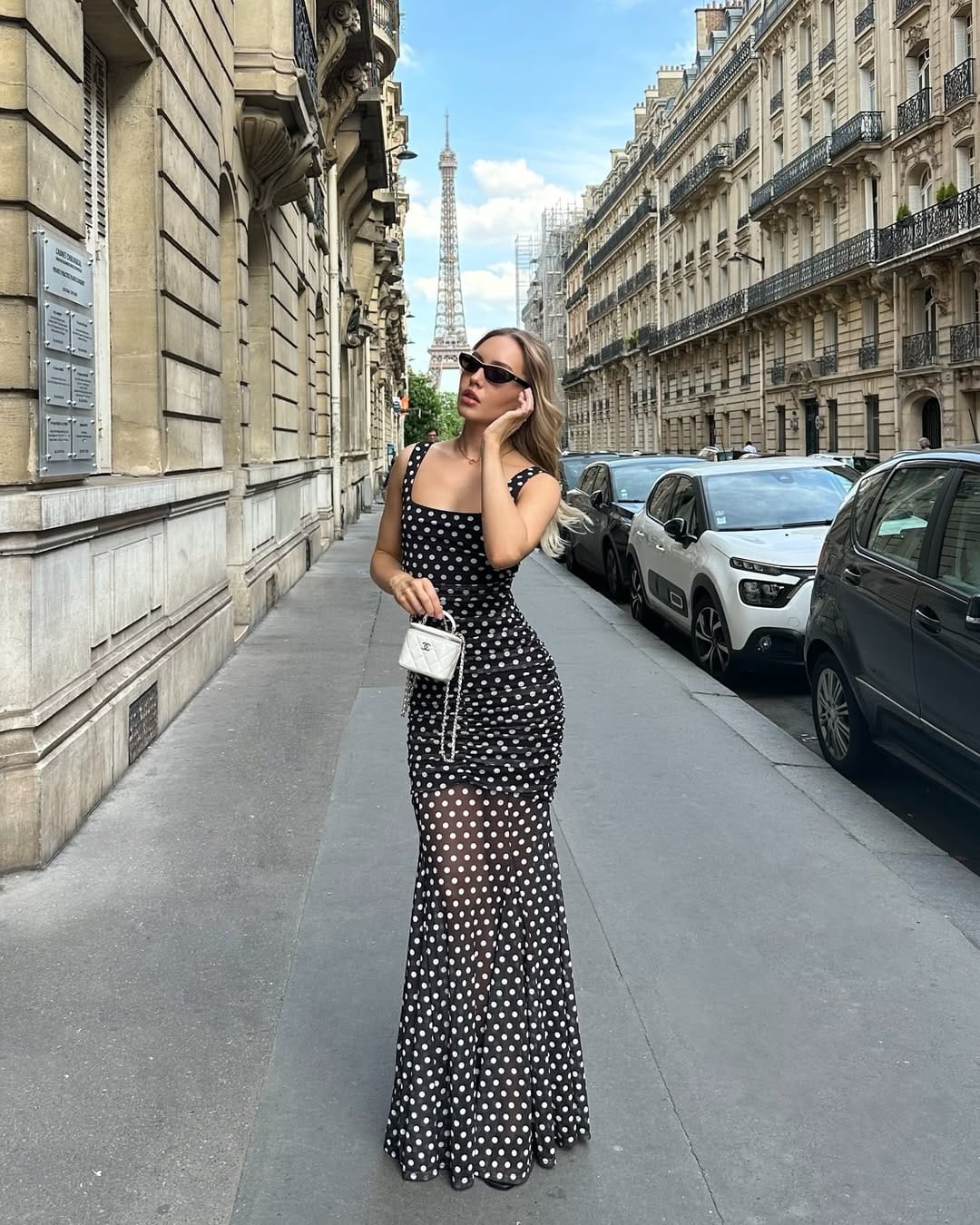 Black polka dot ruched mesh maxi dress styled for an elegant Paris summer evening