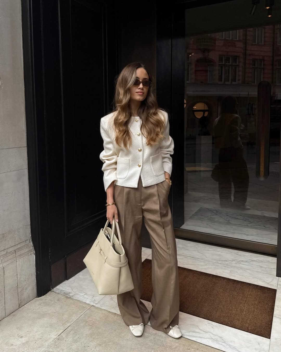 Cream tweed jacket with gold buttons styled with taupe wide-leg trousers