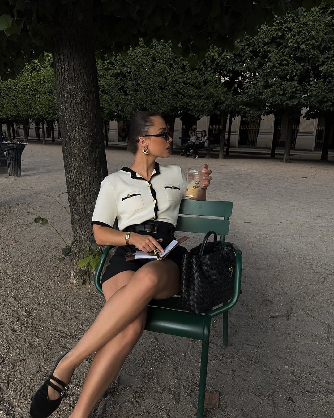 White and black contrast knit top styled with a black mini skirt in the Tuileries