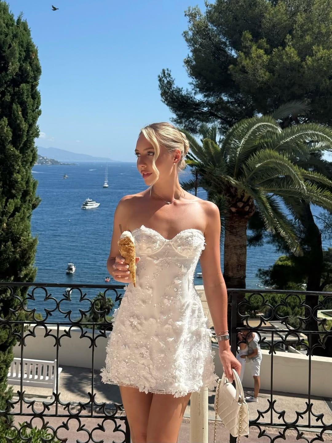 White strapless floral corset mini dress with a mini bag for a feminine concert outfit.