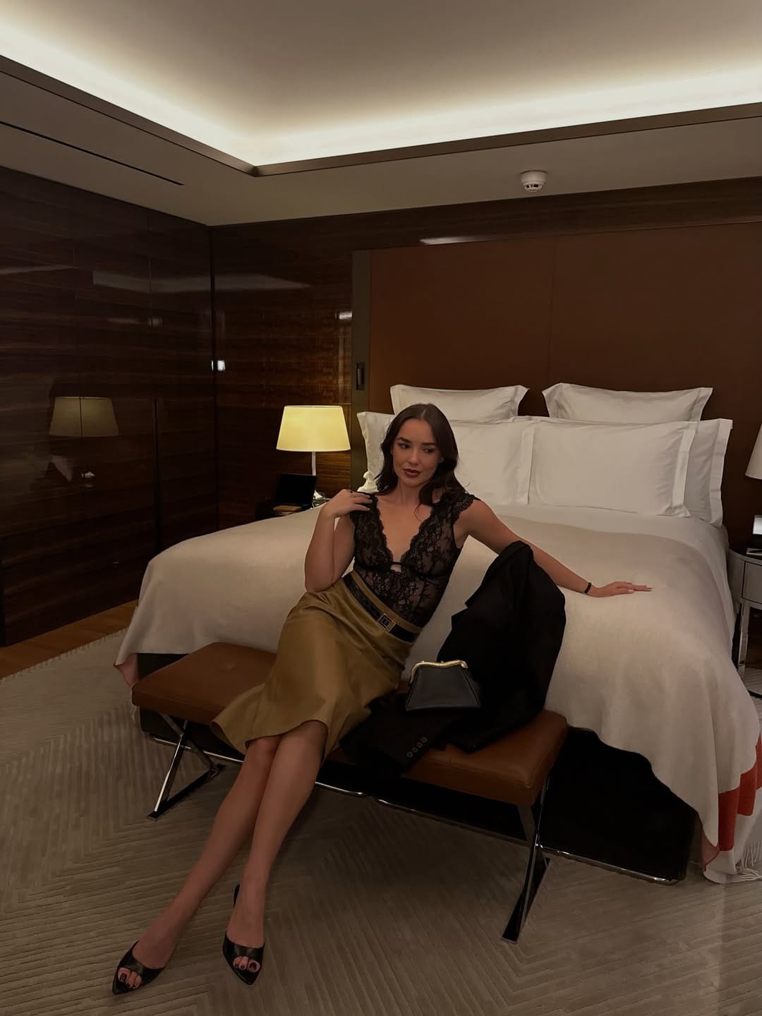 Black lace camisole top paired with an olive satin midi skirt