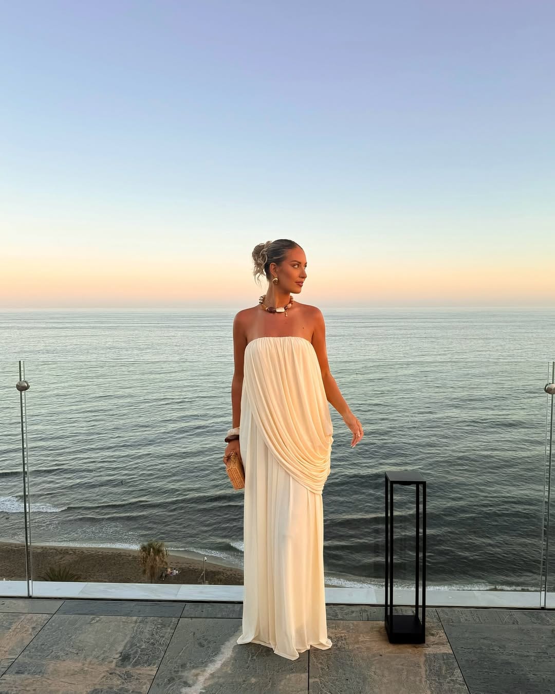 Ivory draped strapless chiffon maxi dress with a flowy silhouette