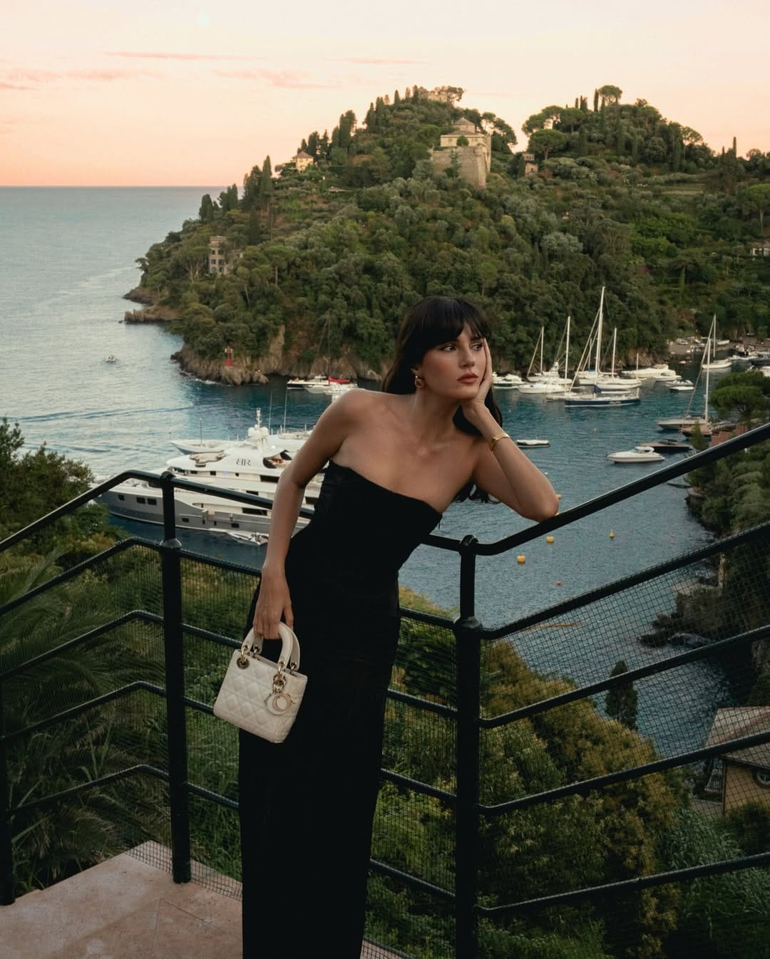 Black strapless column maxi dress styled with a Lady Dior bag