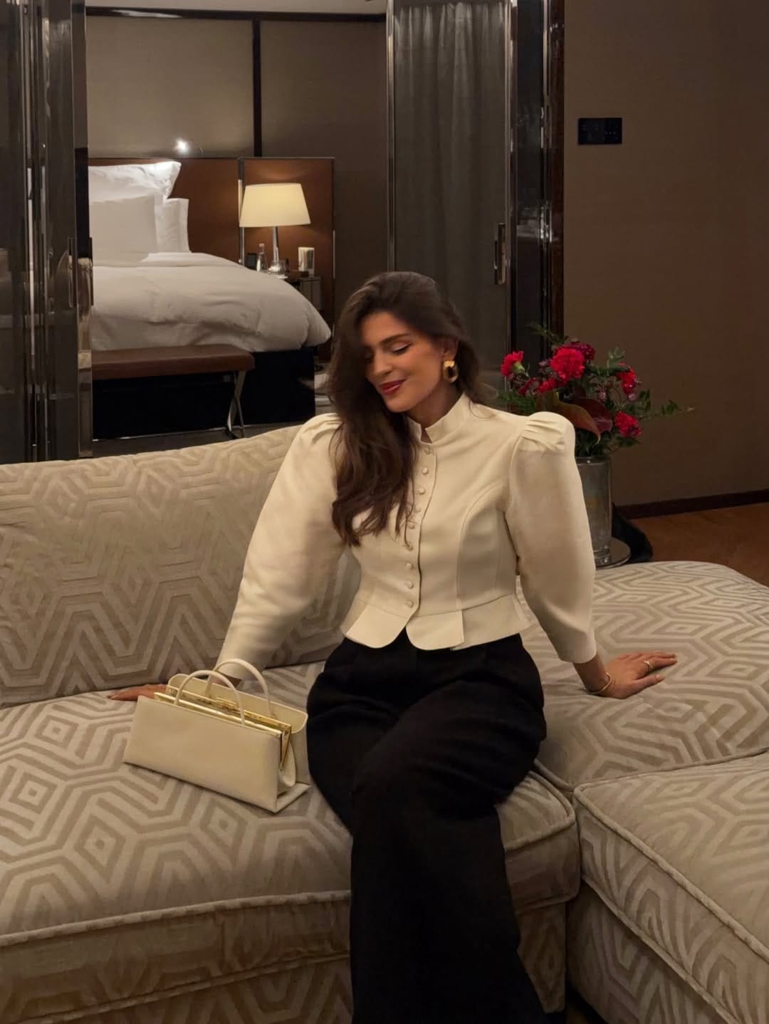 Ivory puff-sleeve structured jacket paired with black wide-leg trousers